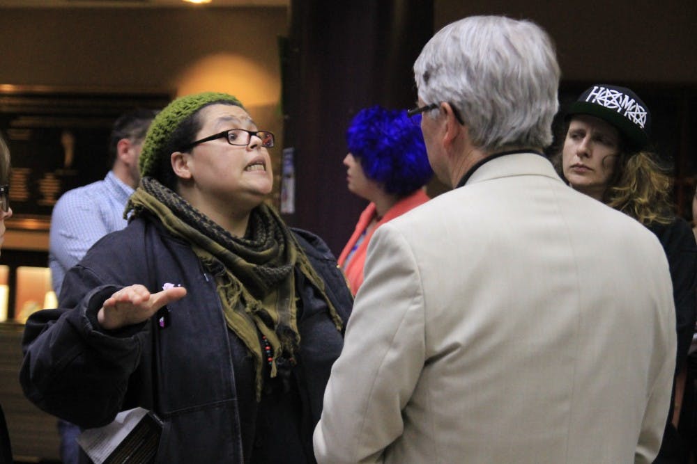 Mayor John Hamilton listens as Jada Bee from the Black Lives Matter movement discusses her beliefs on the Bloomington Police Department's purchase of an armored vehicle. The Bloomington City Council met with Hamilton and Bloomington residents to discuss their concerns Tuesday, Feb. 27.&nbsp;