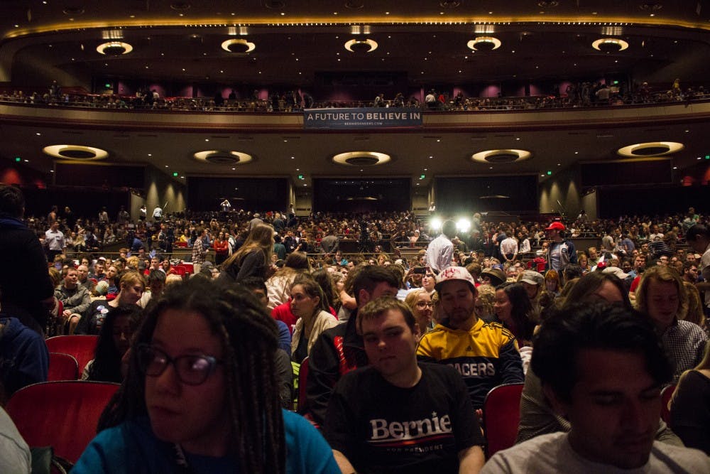 Students stir in the seats before a Bernie Sanders rally Wednesday.  The IU Auditorium was filled to capacity.  
