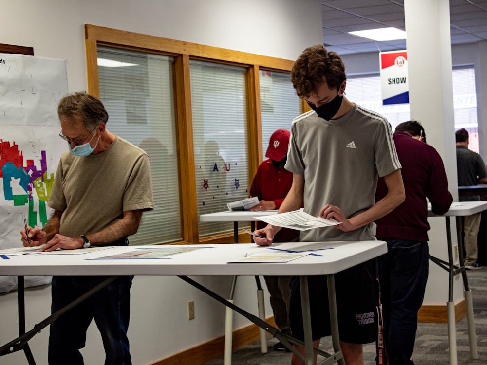 Voters  fill out their ballots during the first day of early voting on Oct. 6 at Monroe County&#x27;s only early voting location.The early voting hours have been expanded due to a large volume of early voters.