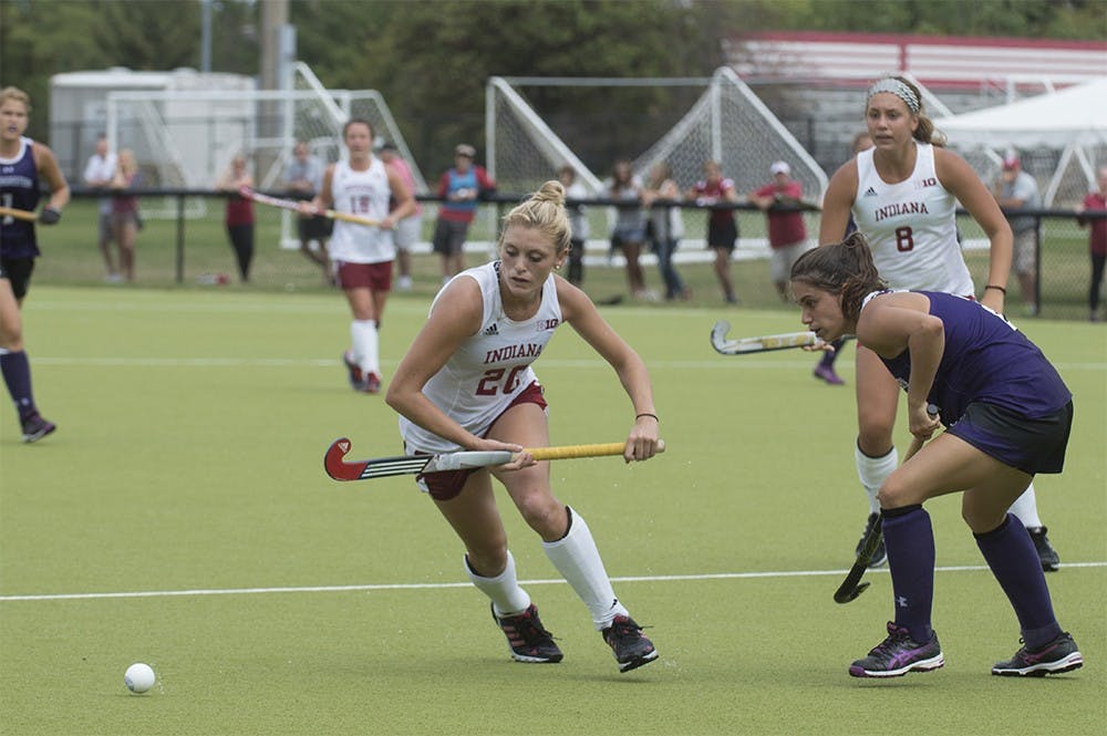IU sophomore forward Maddie Latino tries to get around a Northwestern defender in the game on Oct. 27 at IU Field Hockey Complex. Despite being forced to use a right-handed stick, left-handed Latino has helped the Hoosiers by dominating the left side of the field.