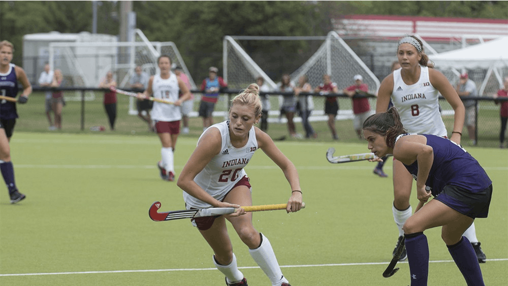 IU sophomore forward Maddie Latino tries to get around a Northwestern defender in the game on Oct. 27 at IU Field Hockey Complex. Despite being forced to use a right-handed stick, left-handed Latino has helped the Hoosiers by dominating the left side of the field.