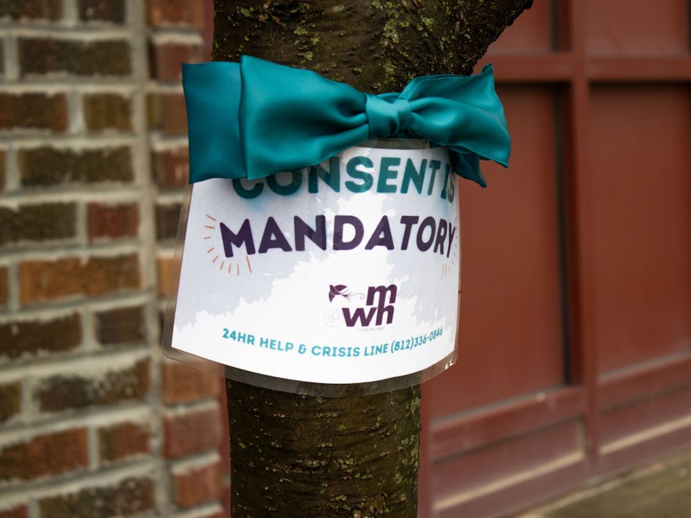 A Middle Way House sign reading &quot;Consent is mandatory&quot; hangs on a tree Sunday. Middle Way House&#x27;s Annual Spring Luncheon will be from 11:30 a.m.-1:30 p.m. Thursday at Switchyard Park.