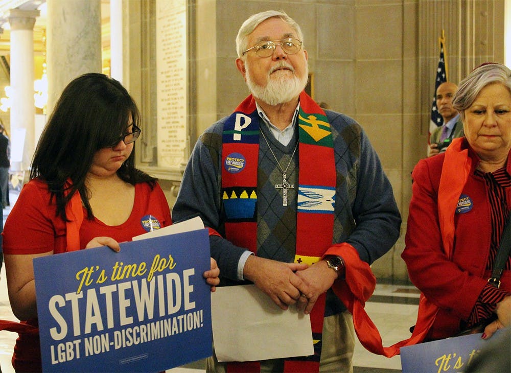 Robert Shaw prays with the faith leaders from Freedom Indiana at the Statehouse Rotunda. Shaw, a retired pastor, wore a liturgical stole to the Statehouse yesterday. 