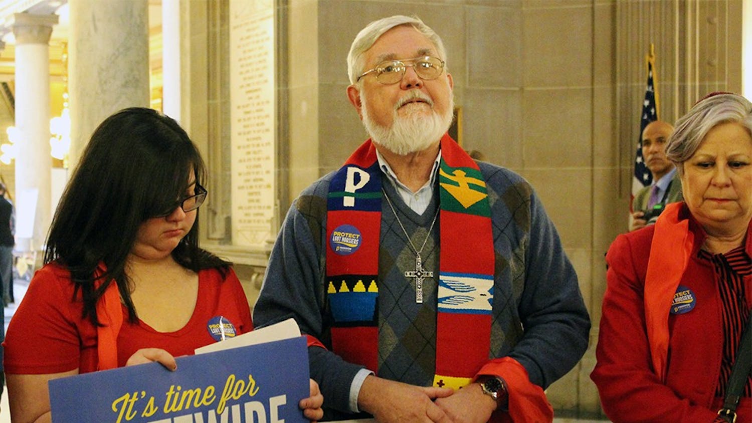 Robert Shaw prays with the faith leaders from Freedom Indiana at the Statehouse Rotunda. Shaw, a retired pastor, wore a liturgical stole to the Statehouse yesterday. 