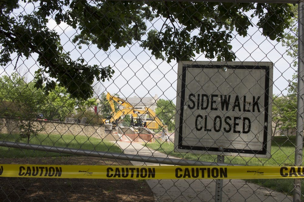 A sign indicating a closed sidewalk stands Monday, May 21, outside the Indiana Memorial Union. Since the summer started, IU has undertaken numerous construction projects around campus.
