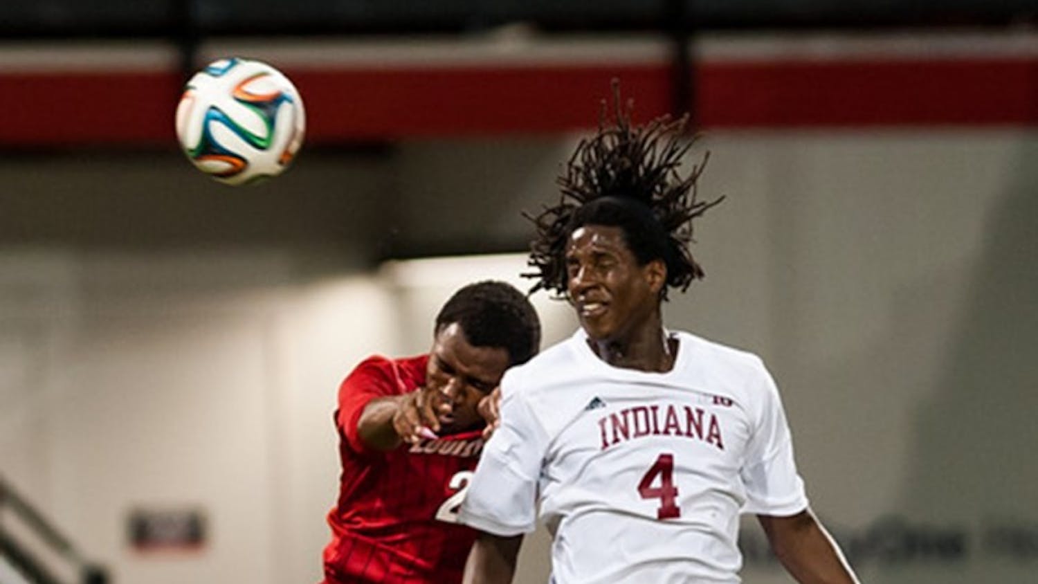 Junior Femi Hollinger-Janzen fights for the ball against Louisville's Michael DeGraffenreidt during IU's game against the Cardinals on Tuesday at Lynn Stadium in Louisville, Ky.