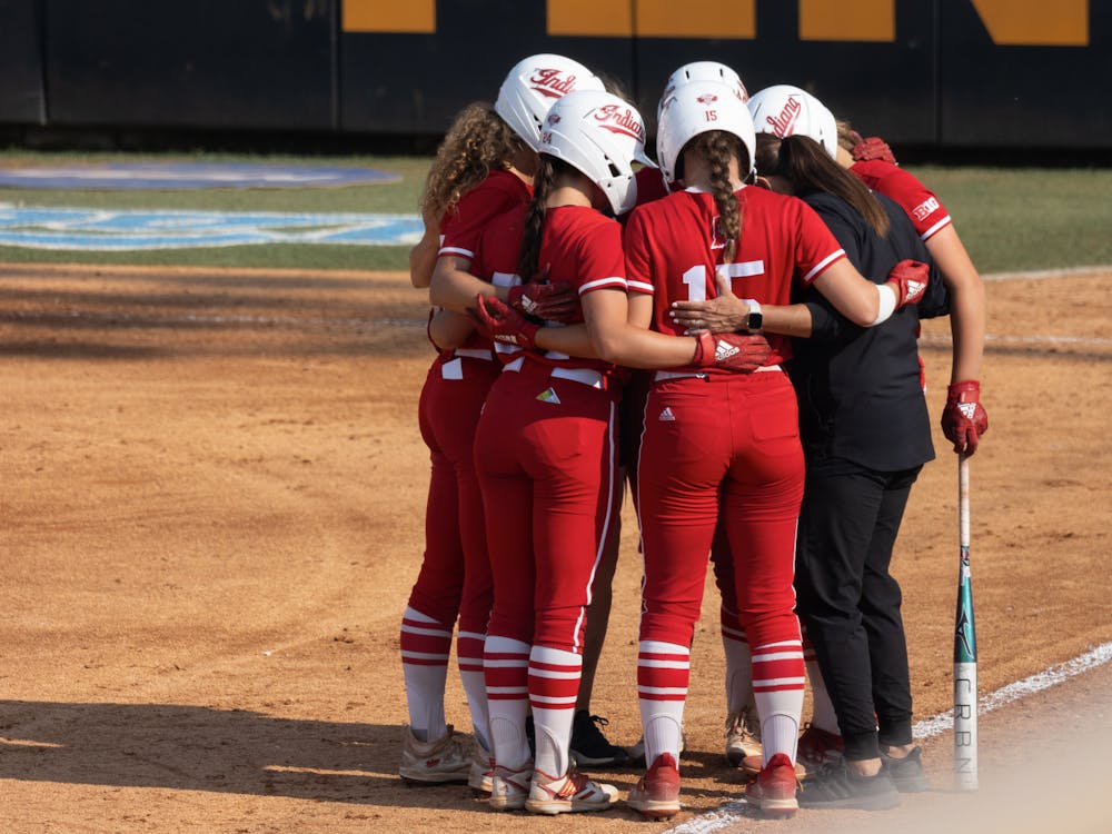 Indiana softball players huddle at the NCAA Tournament against the University of Tennessee May 21. Team 50 had few expectations entering 2023 but ended up with many memories.