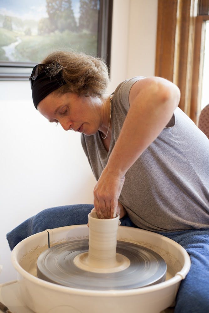 Rebecca Lowery is a Bloomington potter who works in a studio in her garage.  She threw clay on a wheel during a live demonstration at The Venue on Tuesday. 