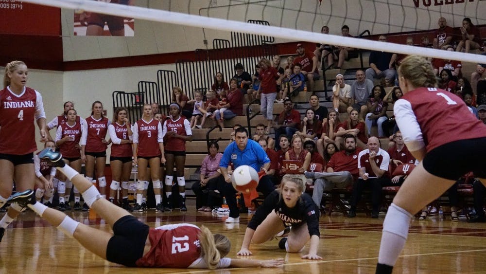 Junior defensive specialist Samantha Fogg and sophomore defensive specialist Meaghan Koors dive to keep the ball alive against Maryland on Sept. 23 at the University Gym. IU is now 1-17 in conference play entering the final two matches of the regular season.&nbsp;
