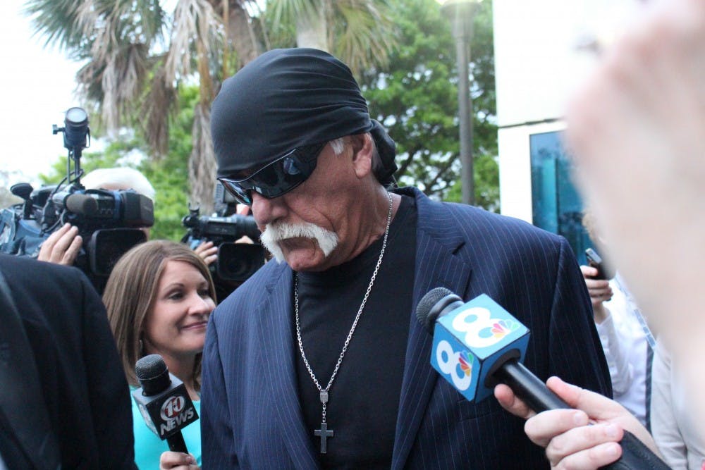 Former professional wrestler Hulk Hogan stands outside the Pinnelas County Courthouse Friday evening. Hogan, whose real name is Terry Bollea, was awarded $115 million in damages after Gawker Media posted a sex tape with him in it on its gossip site.&nbsp;