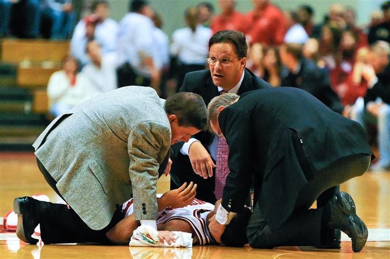 Head basketball coach Tom Crean and team physicians tend to freshman guard Verdell Jones following a hard hit Sunday afternoon at Assembly Hall. 