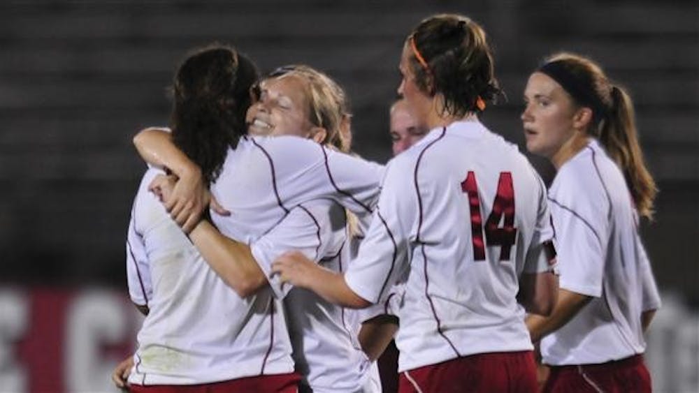 Teammates hug freshman defender Lara Ross after she scored the game-winning goal in the 188th minute against Western Michigan on Wednesday at Bill Armstrong Stadium. The goal was Ross' second of the season.