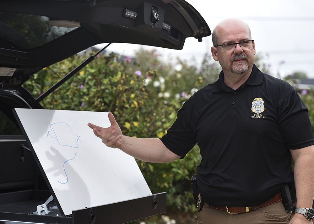 <p>Captain Steve Kellams explains that officers use a foldable whiteboard to draw out plans before arrests. The whiteboard folds back into a case in the back of the vehicle.&nbsp;</p>