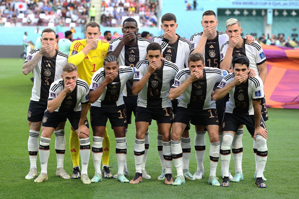 <p>Germany players pose with their hands covering their mouths as they line up for team photos prior to the FIFA World Cup Qatar 2022 Group E match between Germany and Japan Nov. 23, 2022, at Khalifa International Stadium in Doha, Qatar.</p>