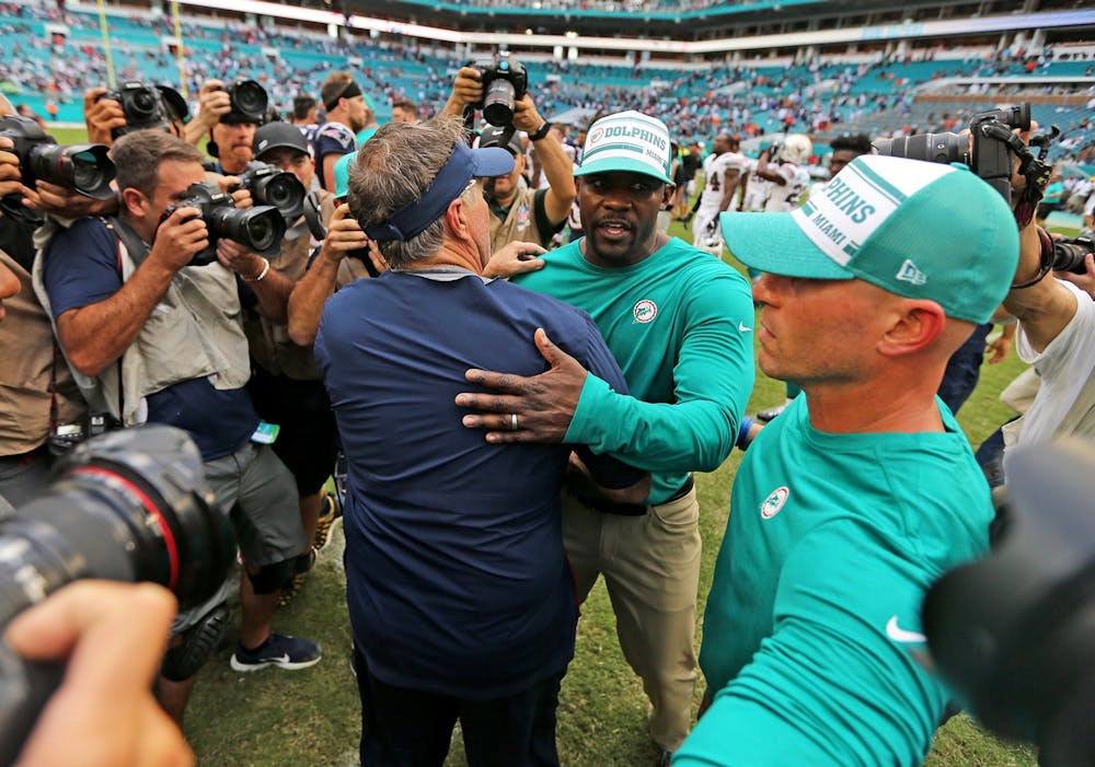 <p>New England Patriots head coach Bill Belichick hugs Miami Dolphins head coach Brian Flores after the game on Sept. 15, 2019, at Hard Rock Stadium in Miami Gardens, Florida. </p>