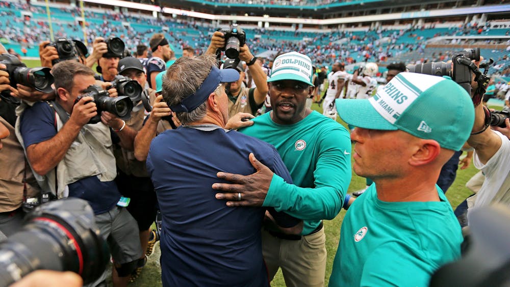 New England Patriots head coach Bill Belichick hugs Miami Dolphins head coach Brian Flores after the game on Sept. 15, 2019, at Hard Rock Stadium in Miami Gardens, Florida. 