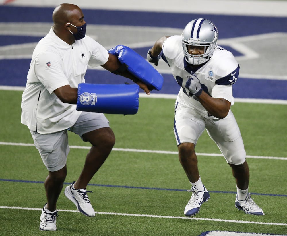 <p>Wide receivers coach Adam Henry trains with a Dallas Cowboy wide receiver on Aug. 23, 2020, in Frisco, Texas. Henry was hired as Indiana&#x27;s wide receivers coach and co-offensive coordinator for the upcoming season.</p>