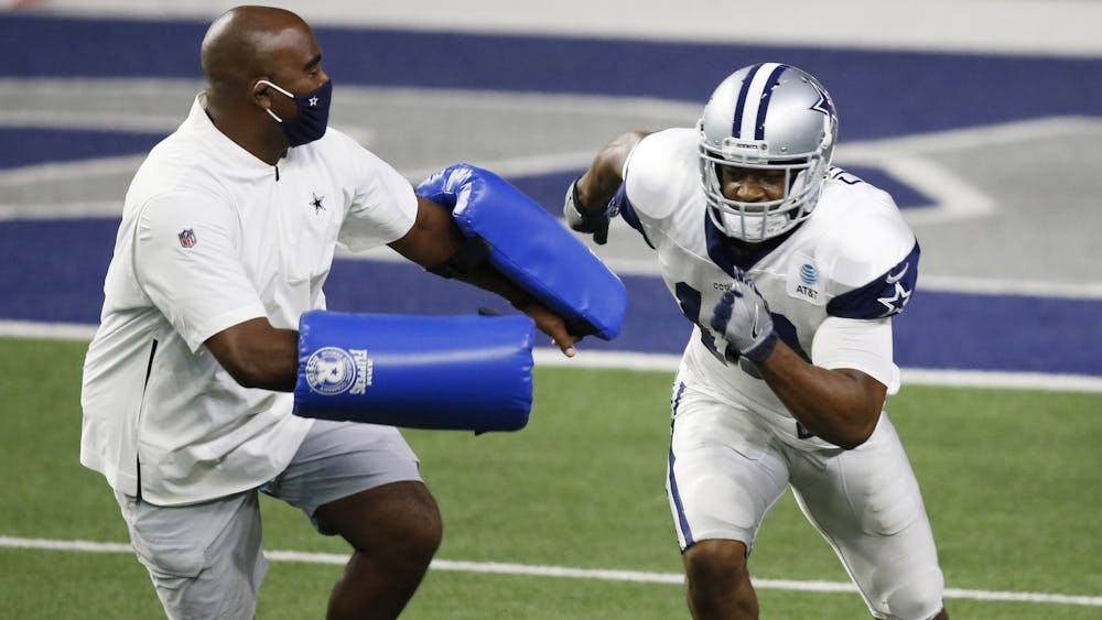 Wide receivers coach Adam Henry trains with a Dallas Cowboy wide receiver on Aug. 23, 2020, in Frisco, Texas. Henry was hired as Indiana&#x27;s wide receivers coach and co-offensive coordinator for the upcoming season.