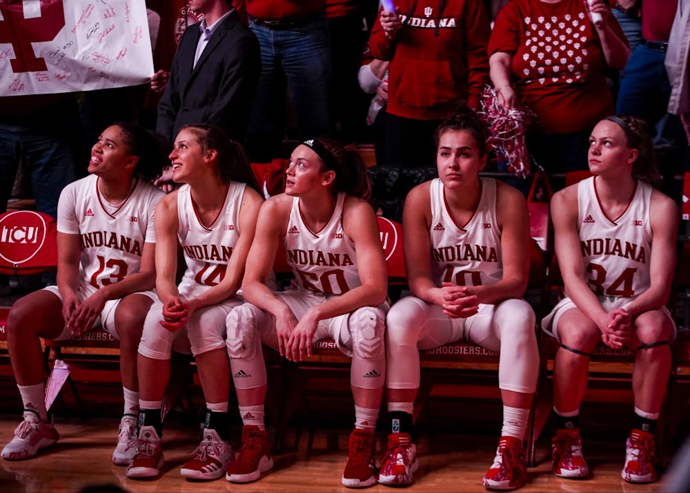<p>The IU women’s basketball starting lineup sits and watches the opening video Feb. 16 at Simon Skjodt Assembly Hall. IU fell from No. 20 to No. 24 in Monday’s AP Poll.</p>