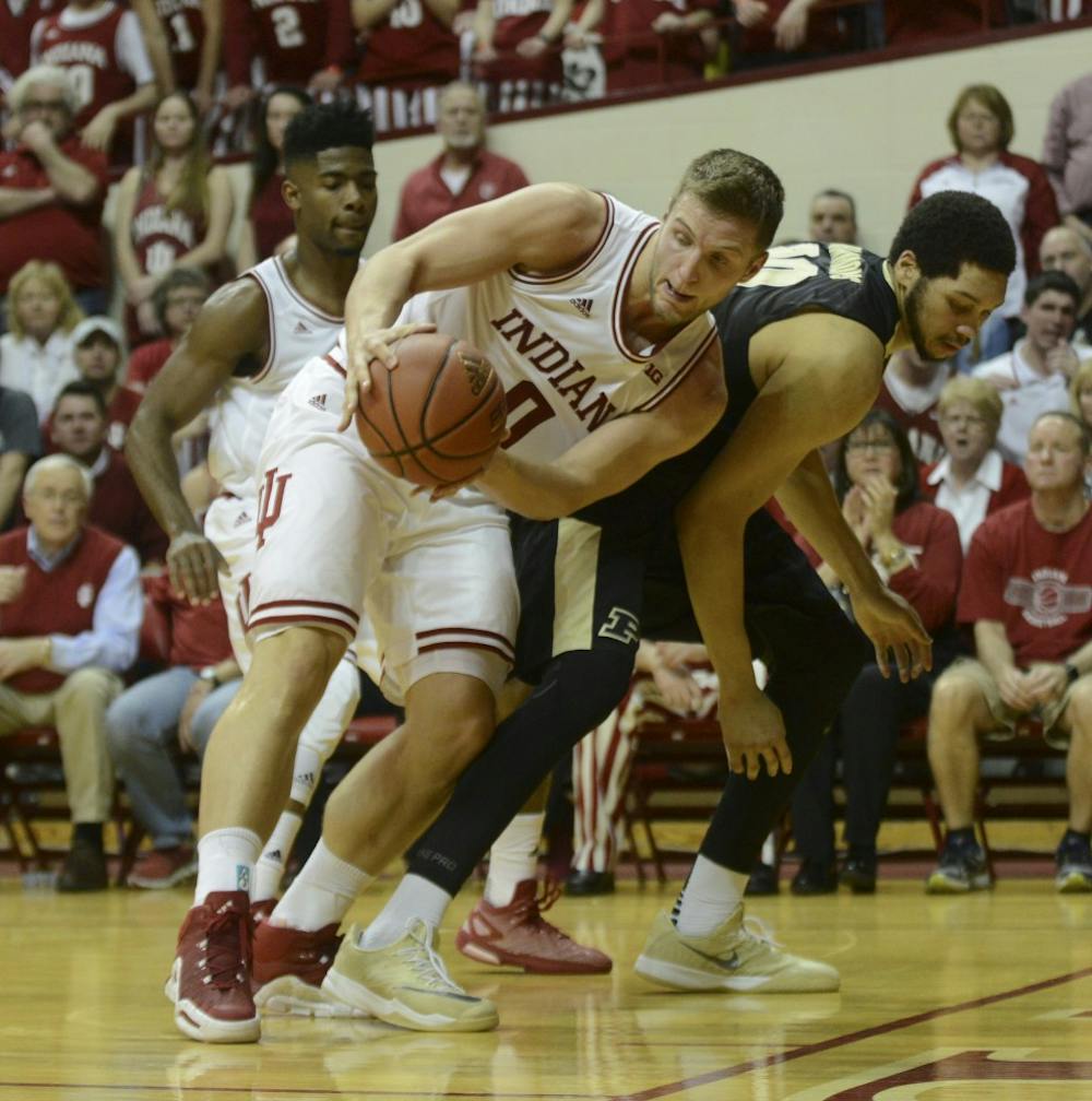 Redshirt senior forward Max Bielfeldt attempts to save the ball from going out of bounds during the game against Purdue on Saturday at Assembly Hall. The Hoosiers won 77-73.