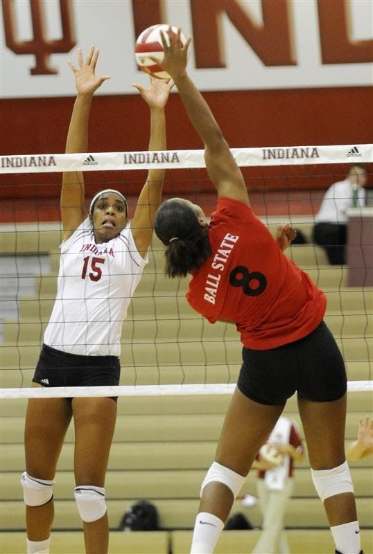 IU senior Erica Short blocks a spike from Ball State junior Alice Green during the TIS Bookstore Invitational on Friday night at University Gym. IU swept Ball State 3-0.
