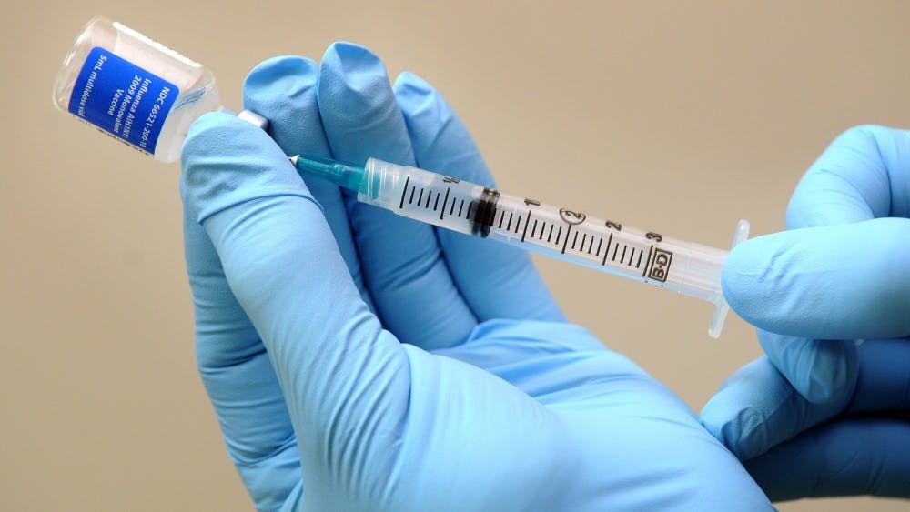 An H1N1 flu vaccine is drawn at a troop medical clinic.