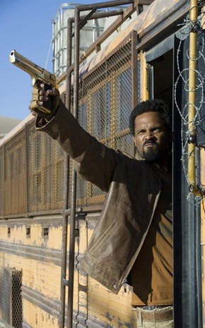 This dude's got all the zombie-hunting essentials; An armored school bus, a big frickin' gun and an "I'm kicking-ass-and-taking-names" look on his face.