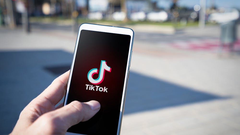The Tik Tok logo is displayed on a student's phone ﻿on April 19, 2023. Congress claims that the RESTRICT Act should be passed to "protect" citizens, deeming TikTok a threat to national security. 
