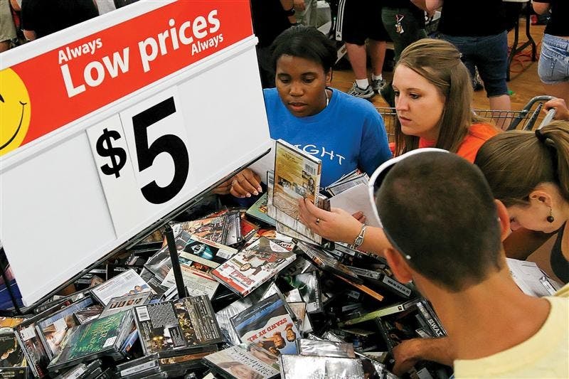 Students rifle through a $5 movie bin during Midnight Madness on Friday night at Wal-Mart. Busses ran continuous shuttles from campus dorms to Wal-Mart from 10 p.m. to 2 a.m. so students could stock up on school supplies and other items.