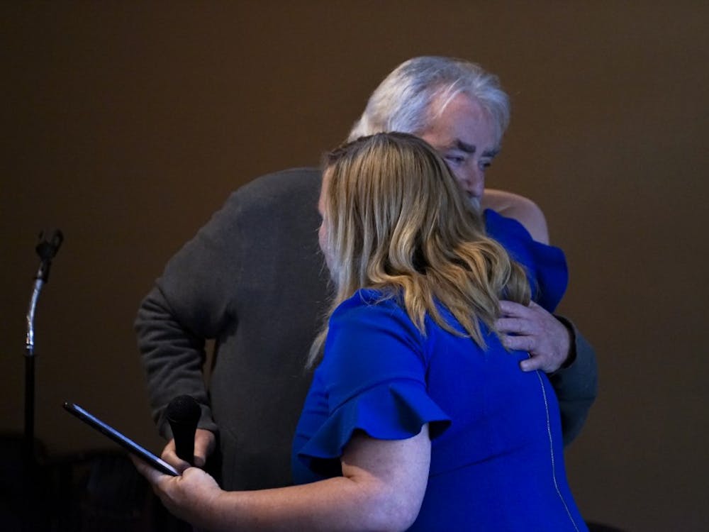 Amanda Barge hugs her father Denny Barge after he gives a speech about a childhood memory that highlighted her listening skills, one of her campaign promises. Barge, the Monroe vice president of the County Commissioners, will run against the current mayor, John Hamilton.