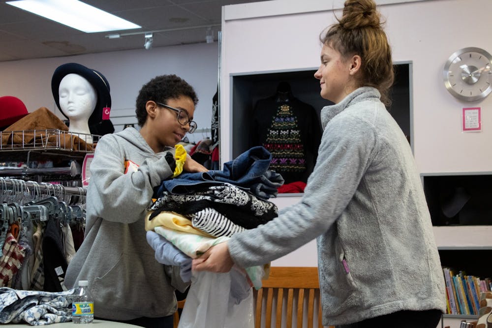 <p>Volunteers 13-year-old Keelyn Moreland, left, and 16-year-old Brianna Hazel, right, place jackets in a bag Jan. 20 in My Sister&#x27;s Closet. They were volunteering as part of My Sister&#x27;s Closet&#x27;s Martin Luther King Jr. Day initiative. </p>