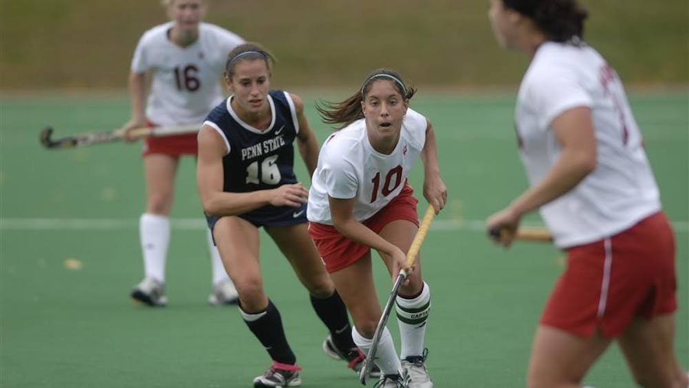 IU's Meg O'Connell dribbles past Penn State's Bethany Marvel Friday at the IU Field Hockey Field. The Hoosiers won 4-1.