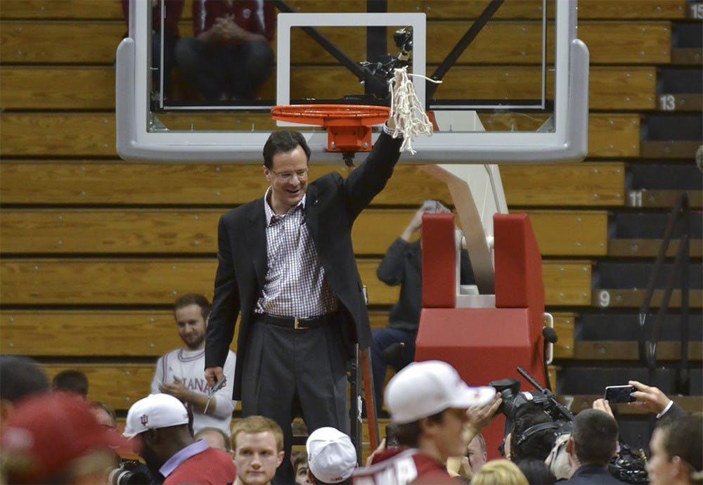 Head Coach Tom Crean holds the net after finishing the regular season on Sunday at the Assembly Hall. 