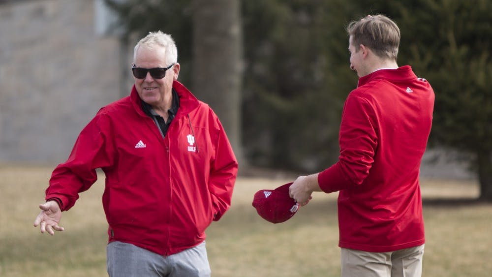 Coach Mike Mayer talks to freshman Evan Yakubov during practice at the IU Golf Course in Jan. 2018. Mayer has been the head coach of IU men's golf for 21 seasons.&nbsp;
