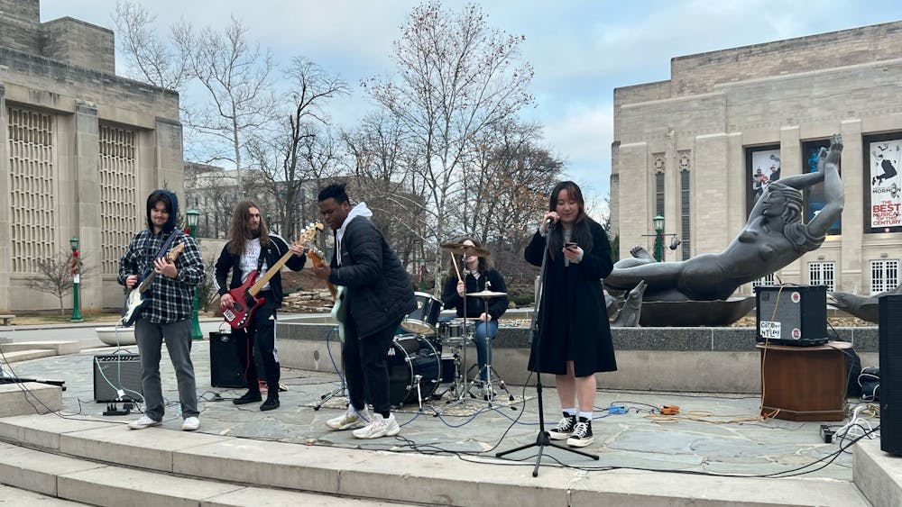 Bloomington metal punk band Perfect 10 performs Dec. 11, 2022, in front of Showalter Fountain. The Bloomington Care Package Concert was organized by local house venues.