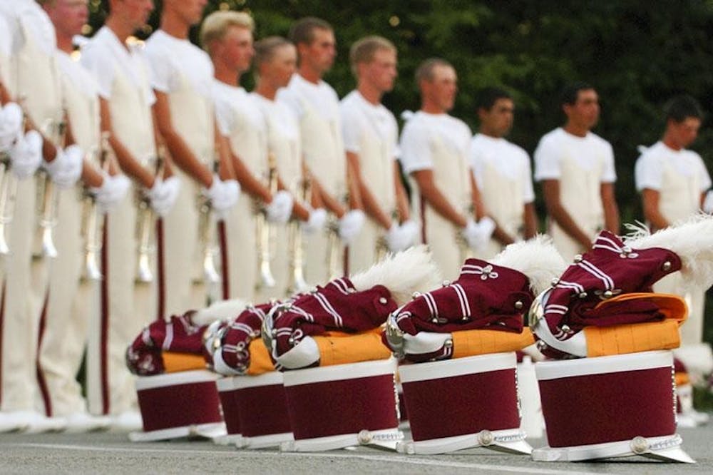 Cadets corps members warm up Tuesday evening at Bill Armstrong Stadium prior to their DCI World Class Quarterfinals performance at Memorial Stadium. Their scores advanced them to the semi-final competition.