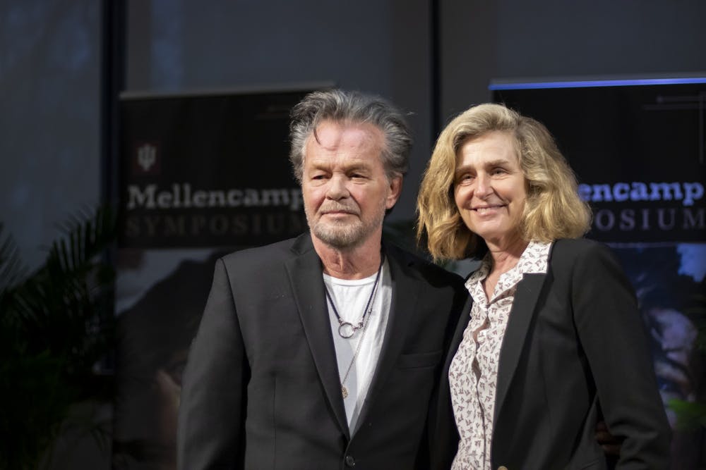 <p>Seymour, Indiana native John Mellencamp and IU President Pamela Whitten pose for a photo together March 3, 2023, at the IU Mellencamp Symposium inside Franklin Hall. Whitten annouced that Mellencamp will donate an achviced collection of his work to IU.</p>