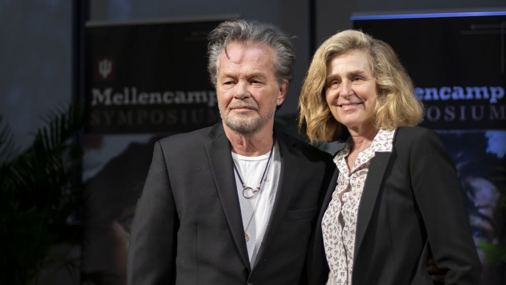 Seymour, Indiana native John Mellencamp and IU President Pamela Whitten pose for a photo together March 3, 2023, at the IU Mellencamp Symposium inside Franklin Hall. Whitten annouced that Mellencamp will donate an achviced collection of his work to IU.
