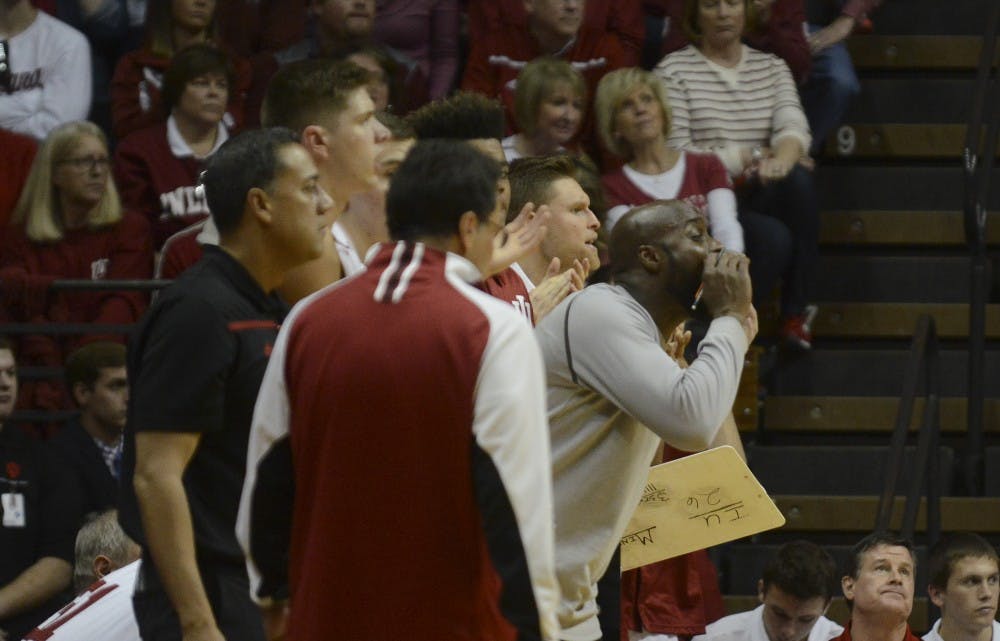Strength coach Lyonel Anderson cheers from the bench during the game against Minnesota on Saturday at Assembly Hall. The Hoosiers won 74-48.