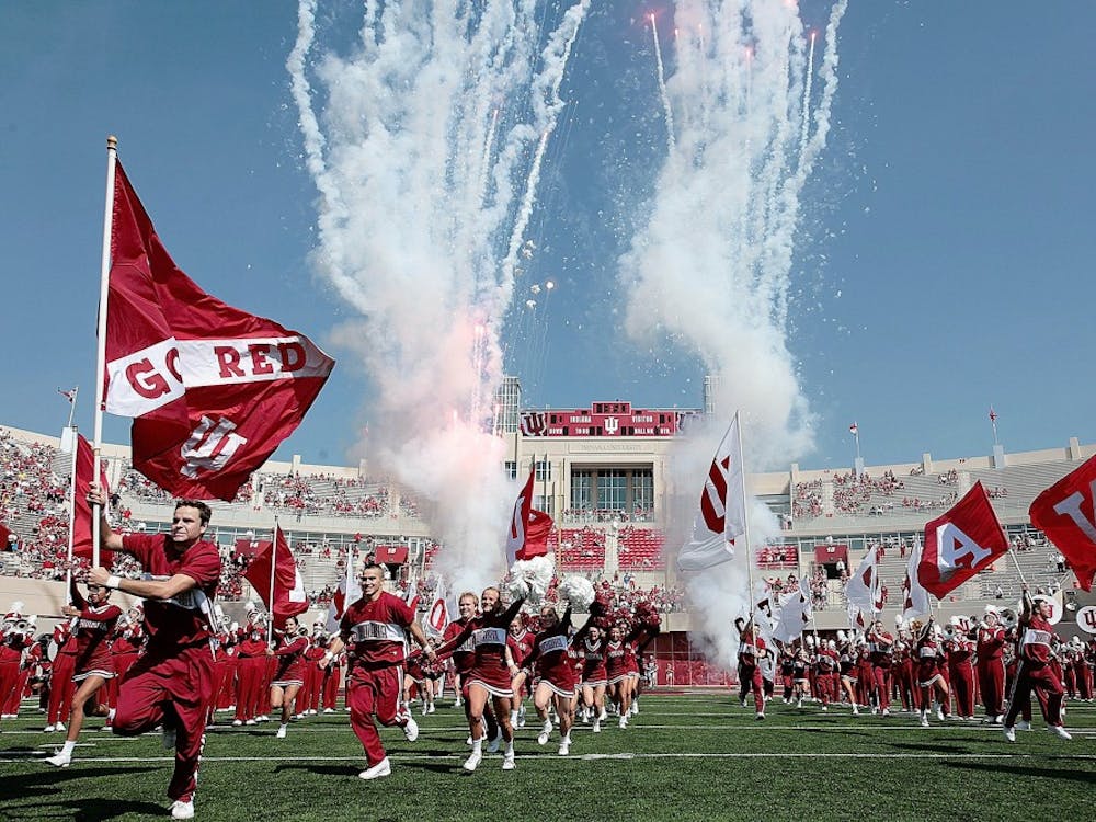 Fireworks, the IU Marching Hundred, and the IU cheerleaders lead the team out of the locker room prior to the Hoosiers 23-19 win over Western Michigan on Saturday afternoon at Memorial Stadium.