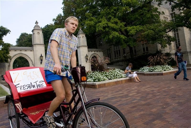Chris Waggoner of Fresh Air Taxis, a taxi service that offers an alternative to driving or taking taxis that run on fuel, poses for a portrait on Monday near the Sample Gates.