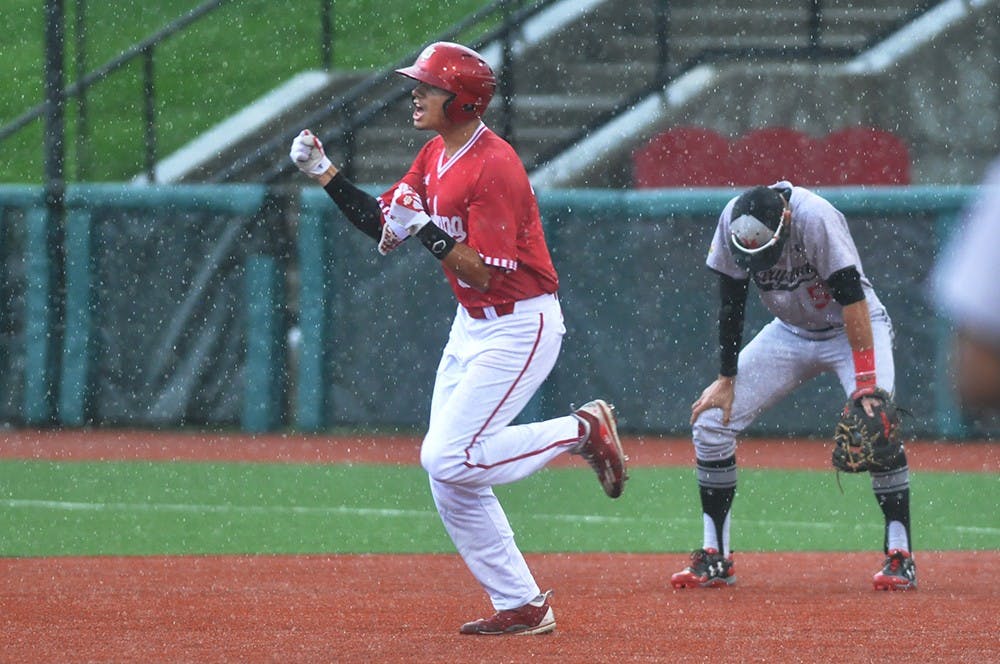 Facing an approaching storm, Craig Dedelow hits a grand slam in the rain to give IU a 6-3 lead in the seventh inning on Sunday, April 30, 2017. The game was delayed by lightning immediately after the home run.