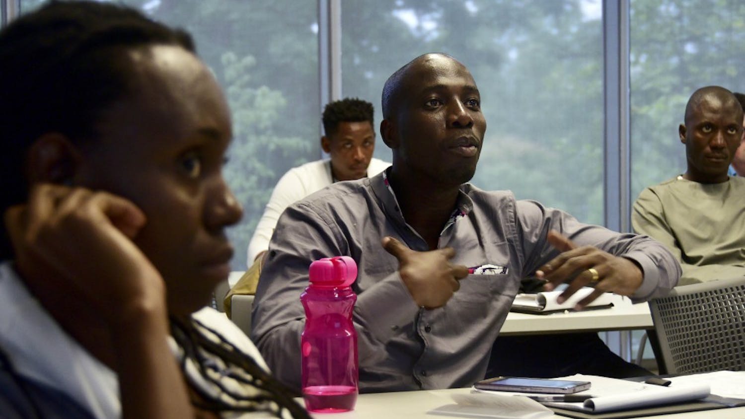 Omer Jose Landry Guehi is talking to Hal Tuner, the speaker, about his thought of the American political system in room 1100 at school of global and international studies on Thursday July 7th. He is amazed about how the system functions, and how different it is from the political system in his country.