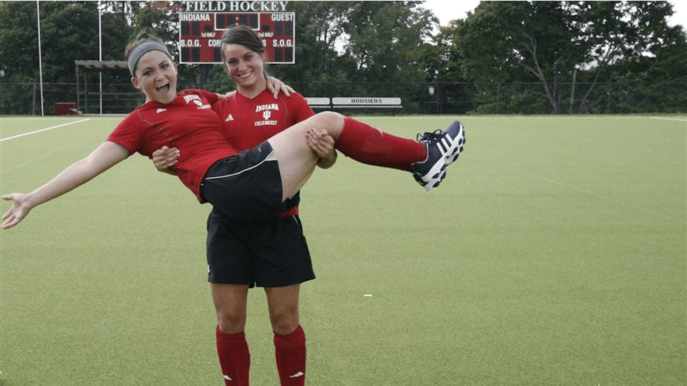 Sisters Lena and Mariella Grote goof around while posing for portraits before field hockey practice on Tuesday at the IU Field Hockey Field.