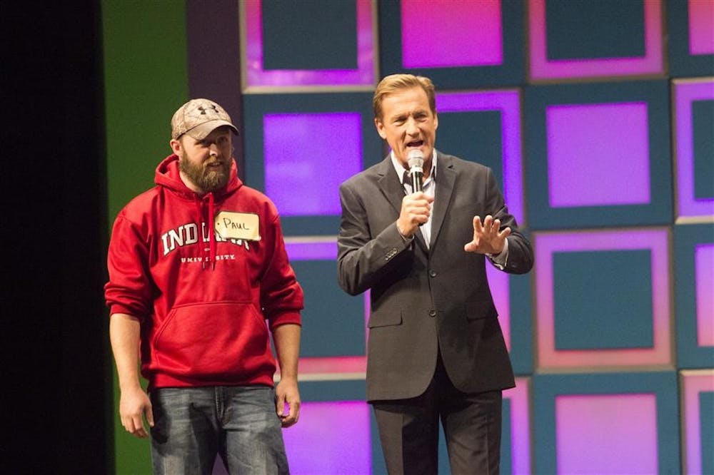 Contestant Paul Brown and host Patt Finn discuss the rules of the game on Thursday at the IU Auditorium. Brown was the first contestant to make it to the stage.
