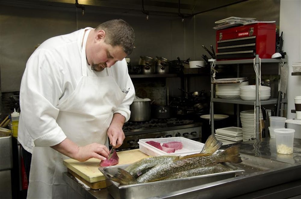 <p>Chef David Tallent, prepares albacore tuna Feb. 22, 2011 in the kitchen.&nbsp;This year Tallent put together Lotus World Music and Arts Festival's lineup of food truck vendors to give attendees a variety of tastes and local ingredients.&nbsp;</p>