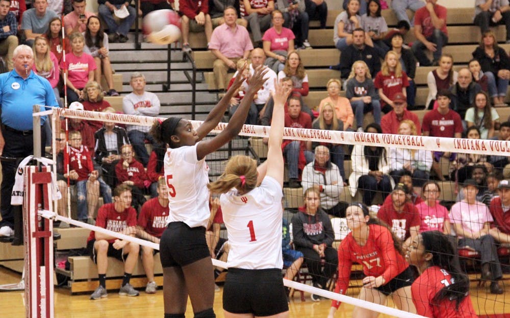 Jazzmine McDonald (left) and Victoria Brisack defend the ball as they compete against Rutgers Scarlet Knight Friday night at the University Gym.