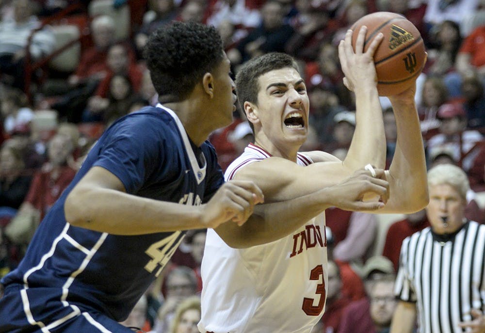 Freshman Max Hoetzel gets fouled as he drives the lane against his defender during IU's game against Penn State on Tuesday at Assembly Hall.