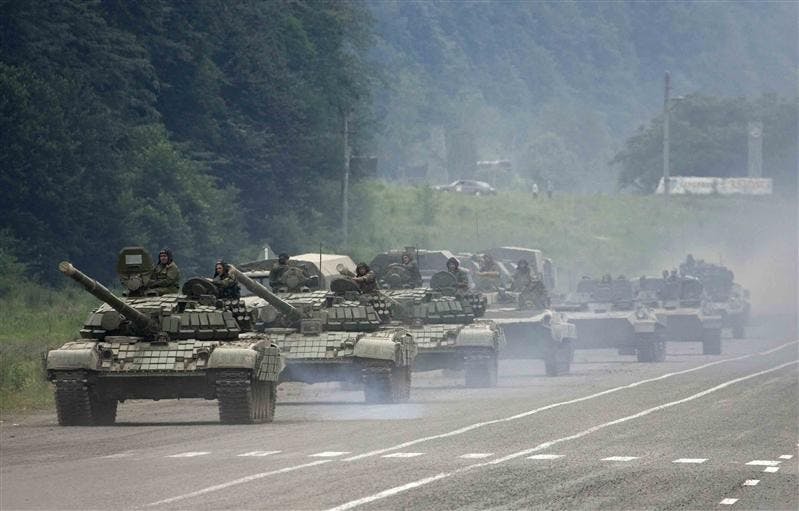 A column of tanks and other armored vehicles roll near the town of Alagir on the road to the border of the Georgian breakaway region of South Ossetia on Saturday.