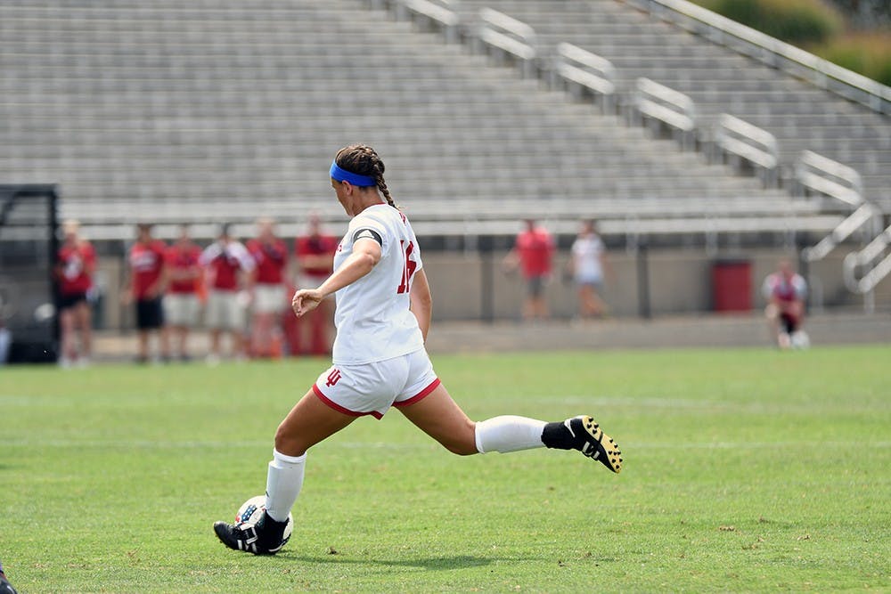 <p>Senior midfielder Kylie Kirk kicks the ball against Clemson on Aug. 20 at Bill Armstrong Stadium. IU released its 2018 schedule Tuesday.&nbsp;</p>